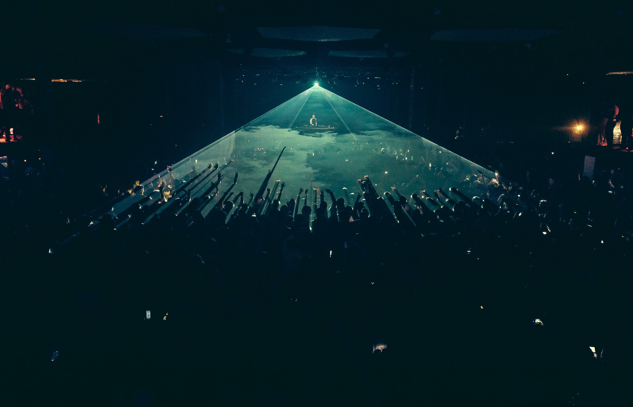 Concert stage with dramatic triangular laser and LED projection over the crowd