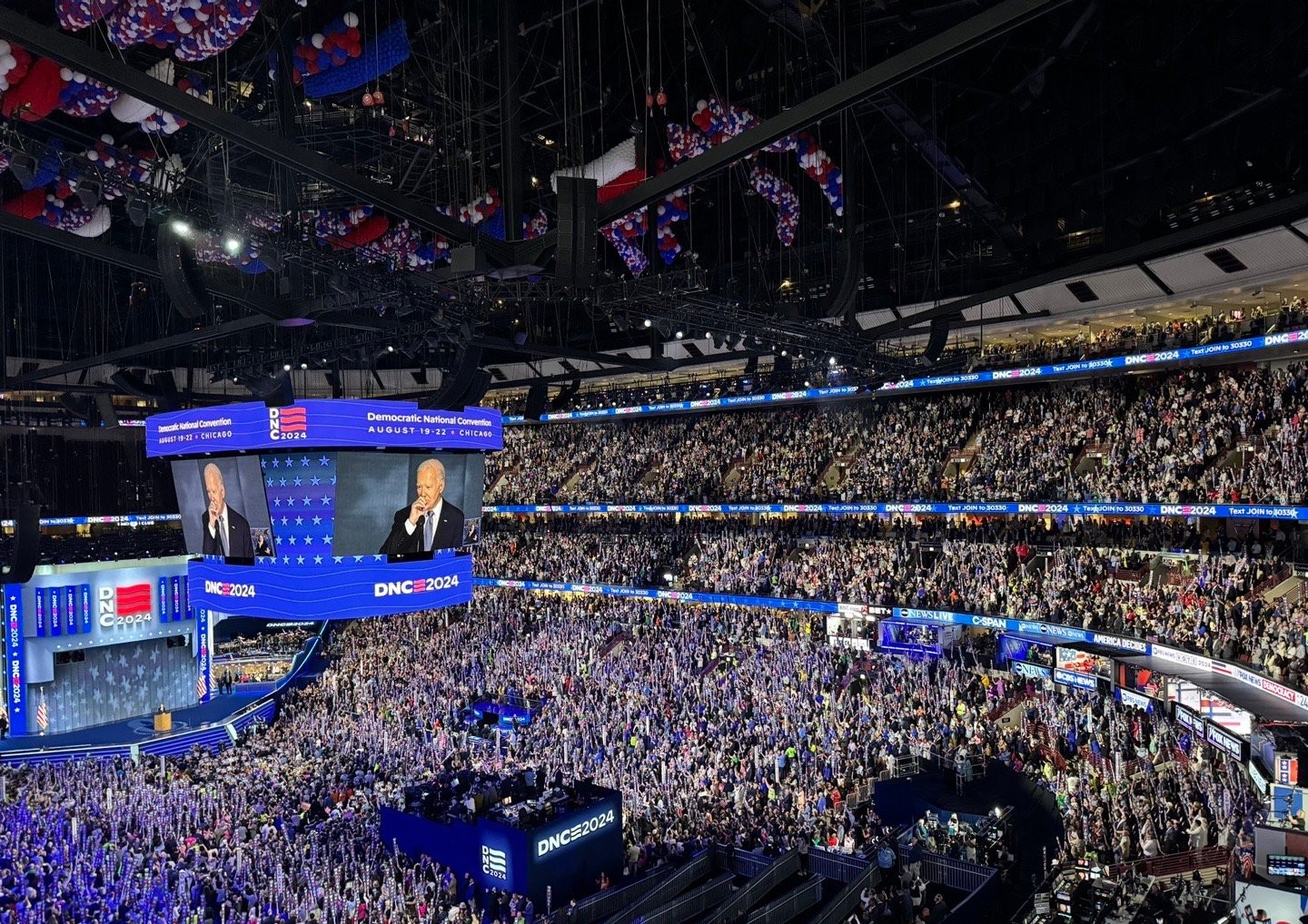 Large arena convention stage with LED screens and live broadcast
