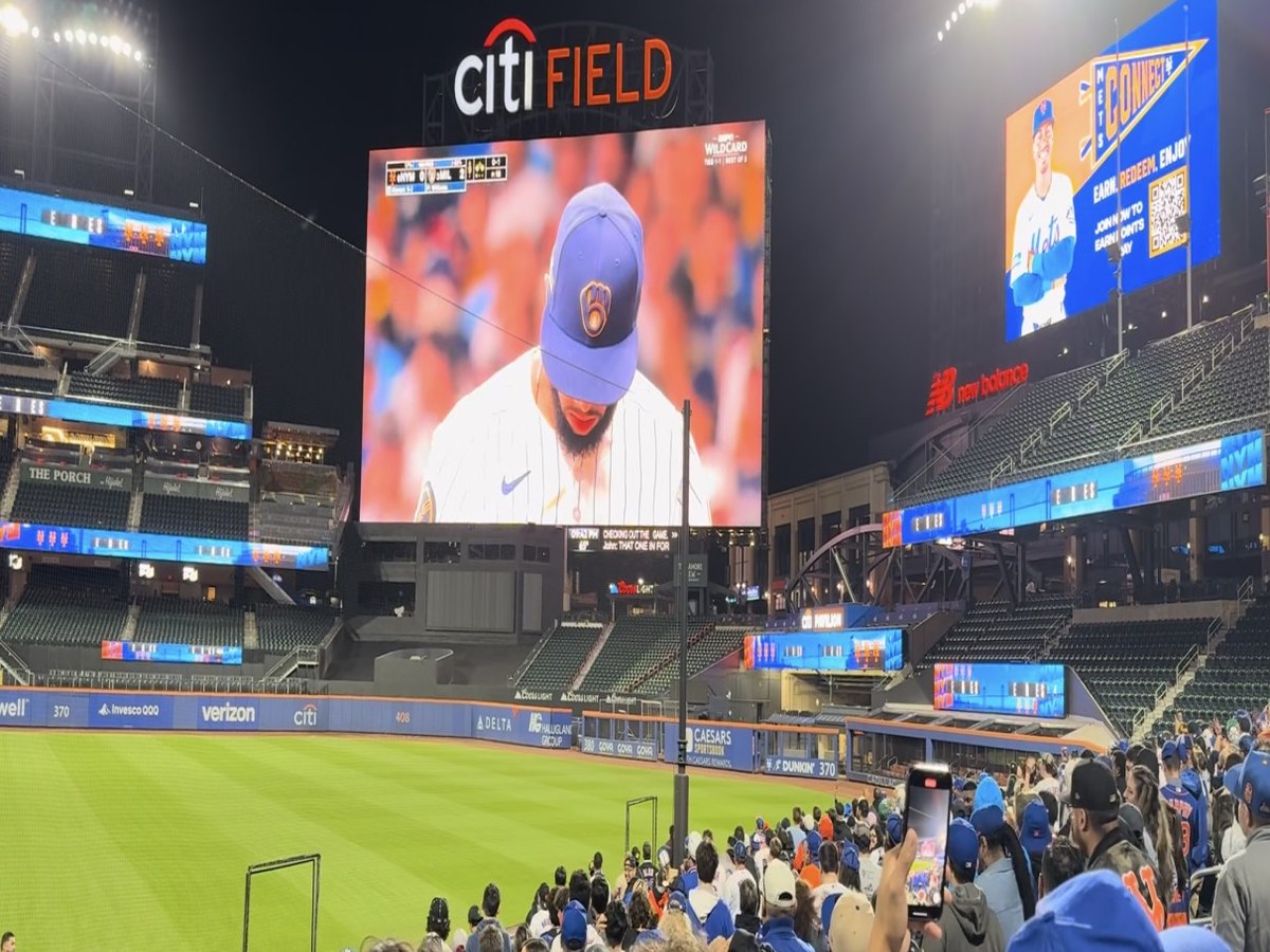 Night baseball stadium with a large LED scoreboard